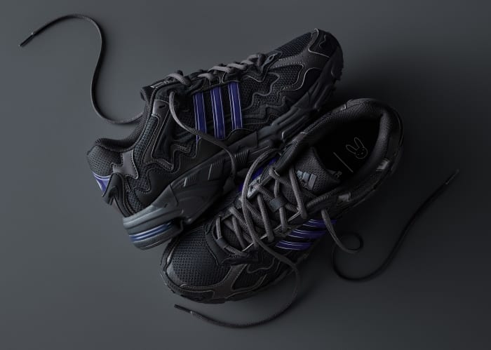 View of Bad Bunny's black and blue adidas sneakers.